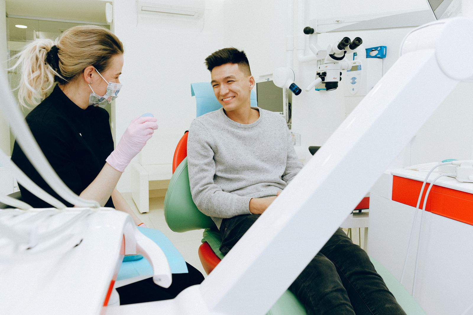 Patient smiling in a dental chair during a consultation