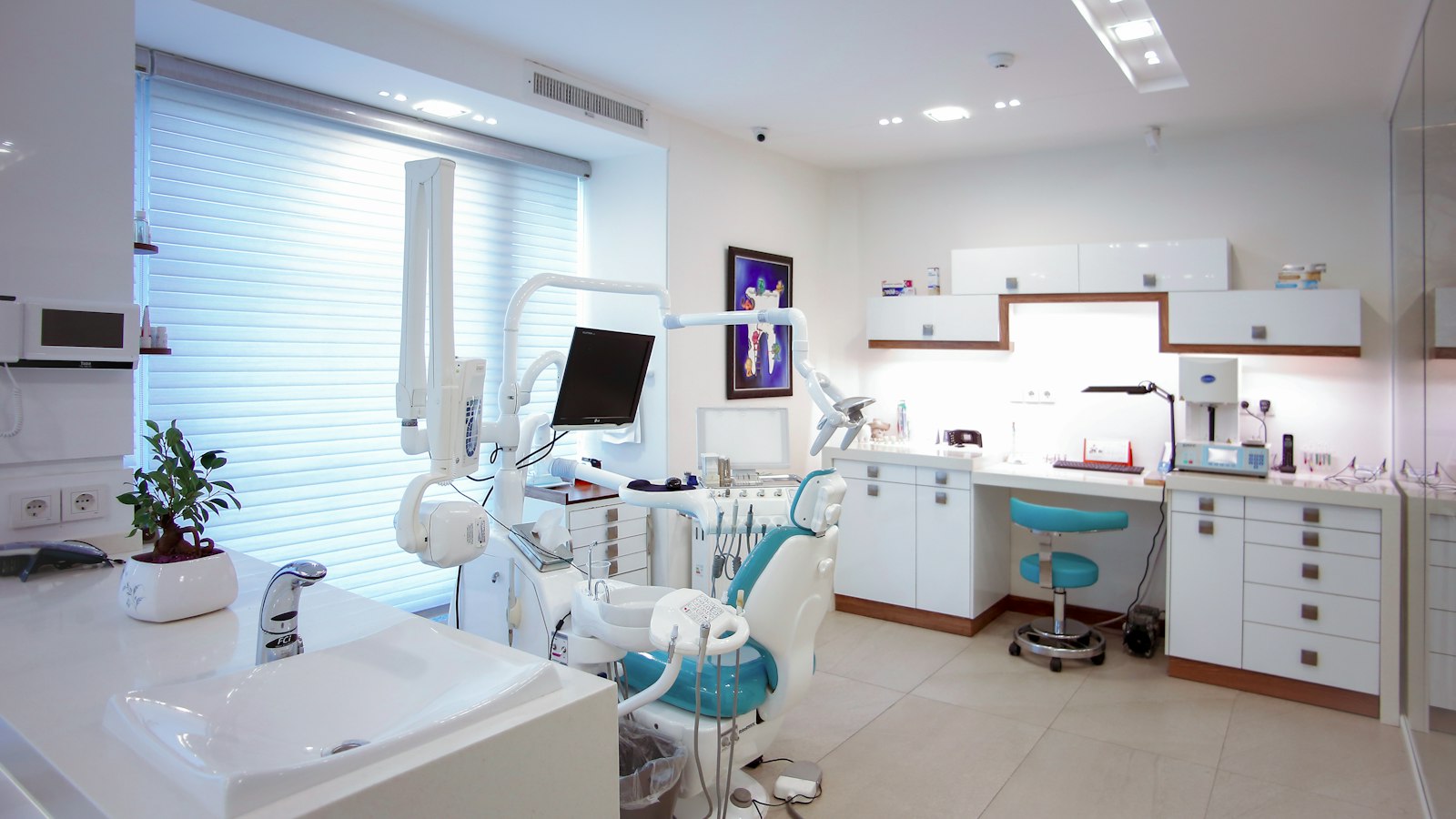 Private UK dental treatment room with chair, delivery unit and consult desk